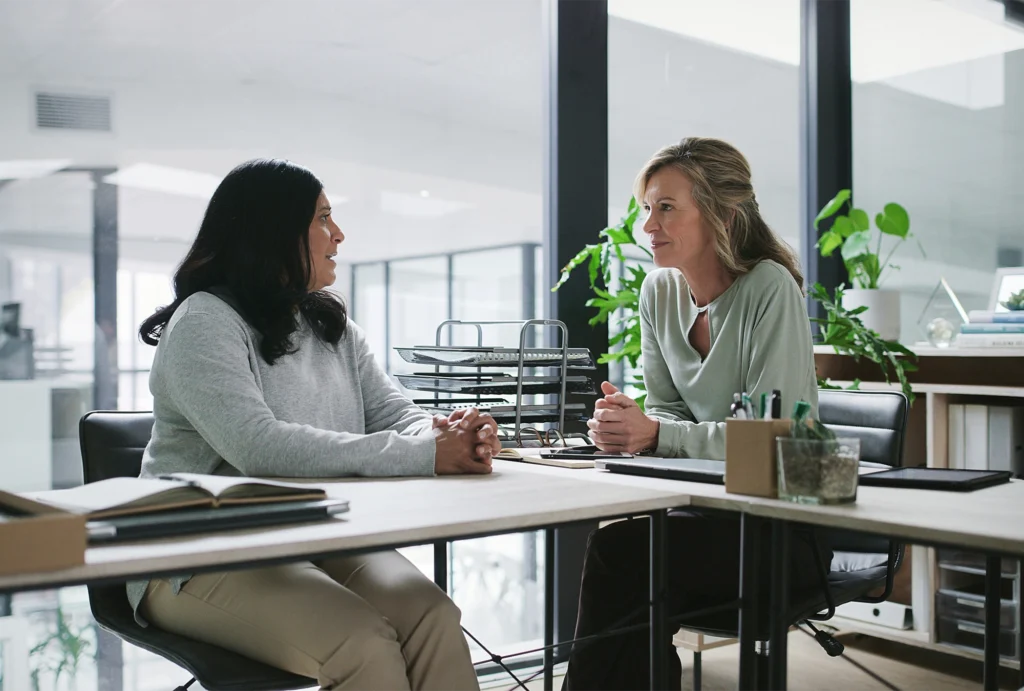 Two women discussing fiduciary responsibilities